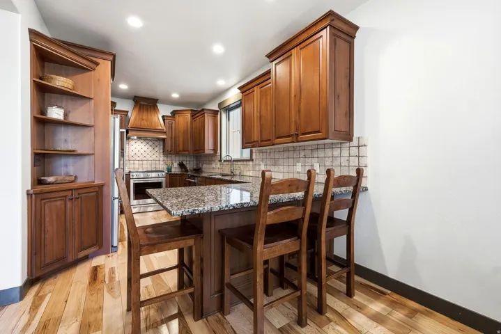 Kitchen featuring wood-finish flooring, recessed lighting, and built-in wood cabinetry