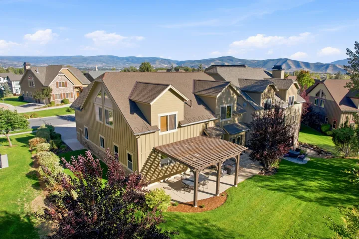 Expansive backyard with a large patio featuring a wood pergola