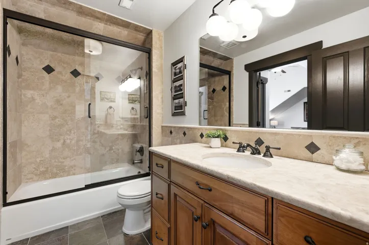Wood-finish vanity with an undermount sink and light-toned countertop