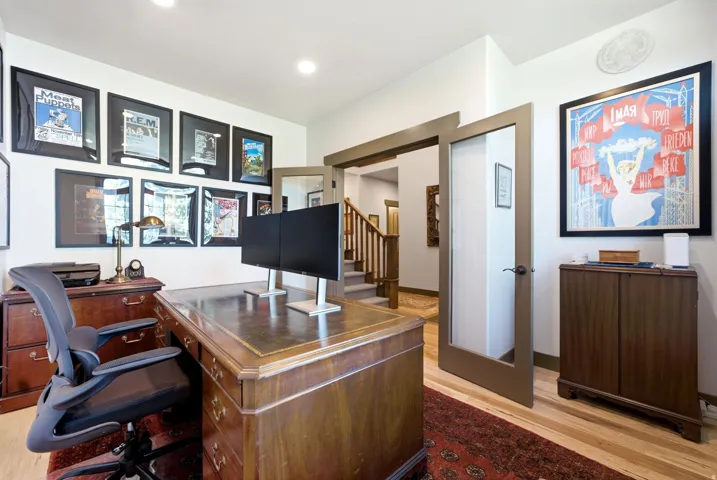 Hardwood flooring, recessed lighting, and a built-in wood cabinet