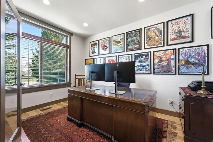 Hardwood flooring, recessed ceiling lighting, large window with blinds, and glass-paneled entry door