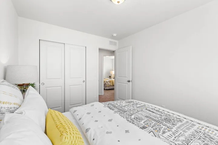 White interior walls, two-panel sliding closet doors, and a flush mount ceiling light