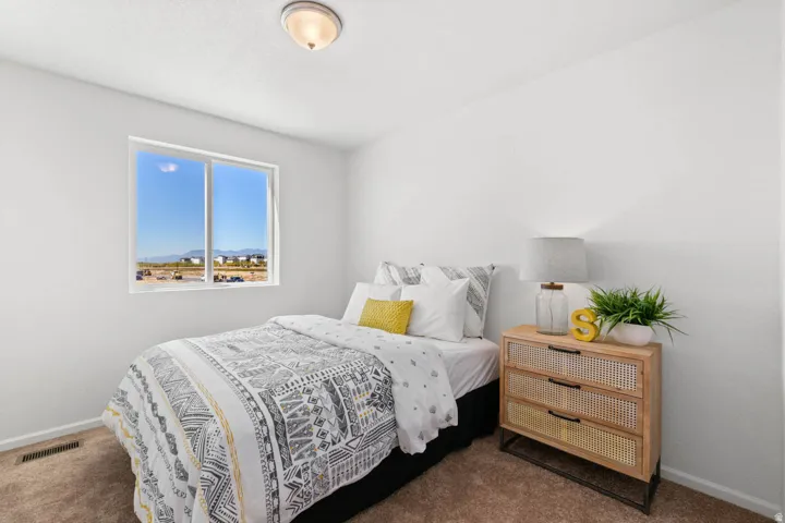 Neutral wall color, carpeted flooring, and a single window