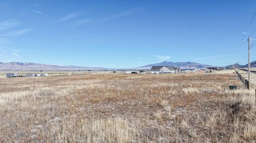 Expansive open land with surrounding mountainous terrain