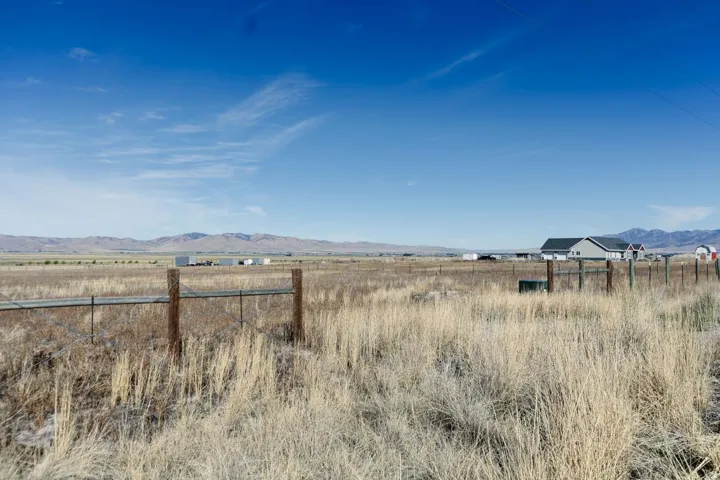 Expansive open land with a distant mountain backdrop