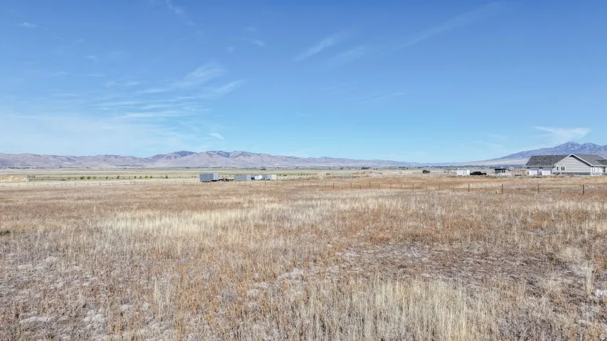 Expansive open land with distant mountain ranges