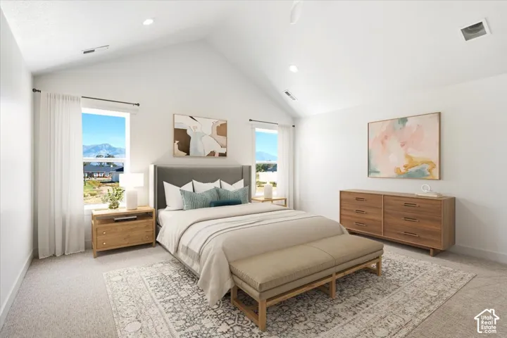 Vaulted ceilings, neutral carpeted flooring, recessed lighting, and windows featuring mountain backdrops