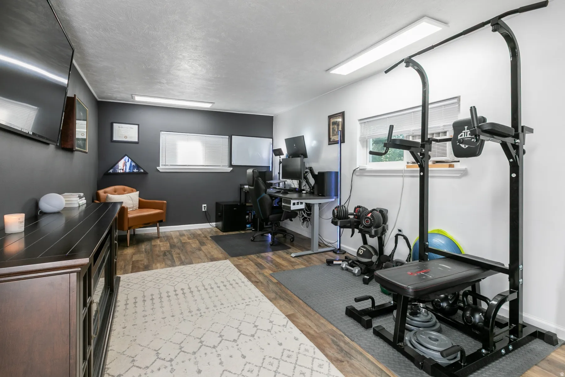 Office Room featuring wood-finish flooring, recessed lighting, split HVAC for cooling and heating. Electric Fireplace.  Water is accessible to the office. Can be used for exercise room, hobby room or guest room.