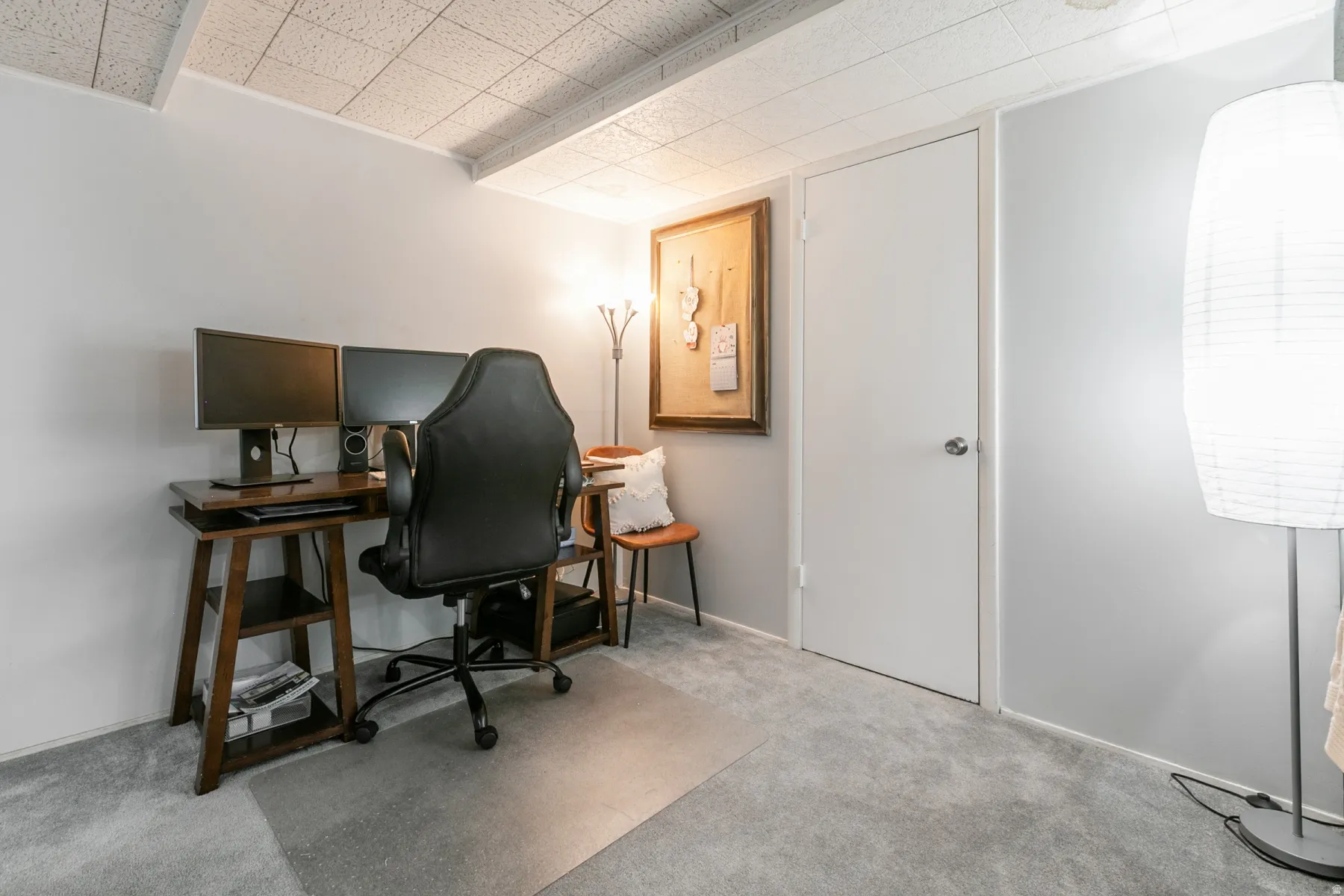 Recessed ceiling with acoustic tiles, light gray wall finishes, and gray carpeting