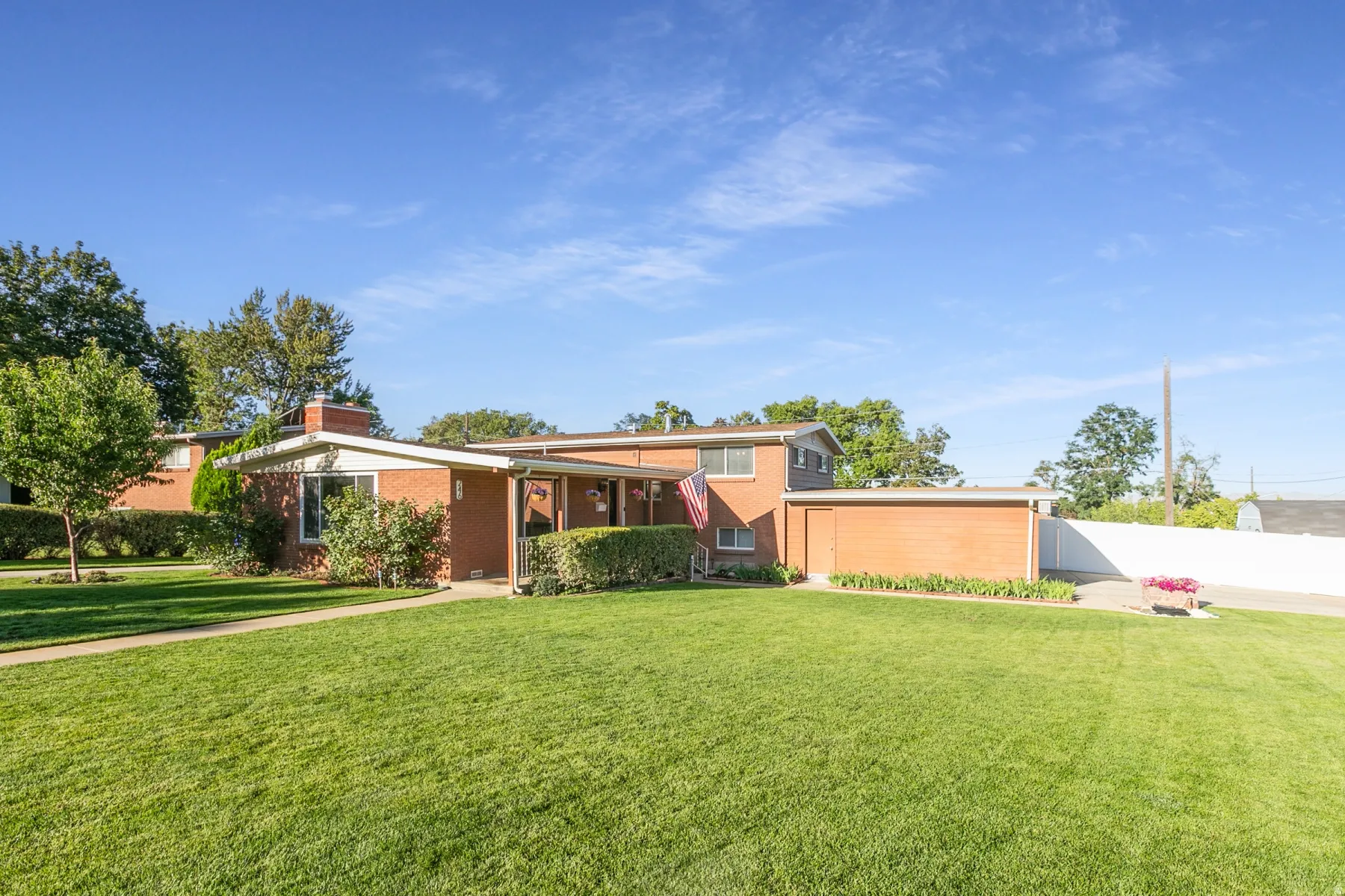 View of the from the corner showing immaculate landscaping