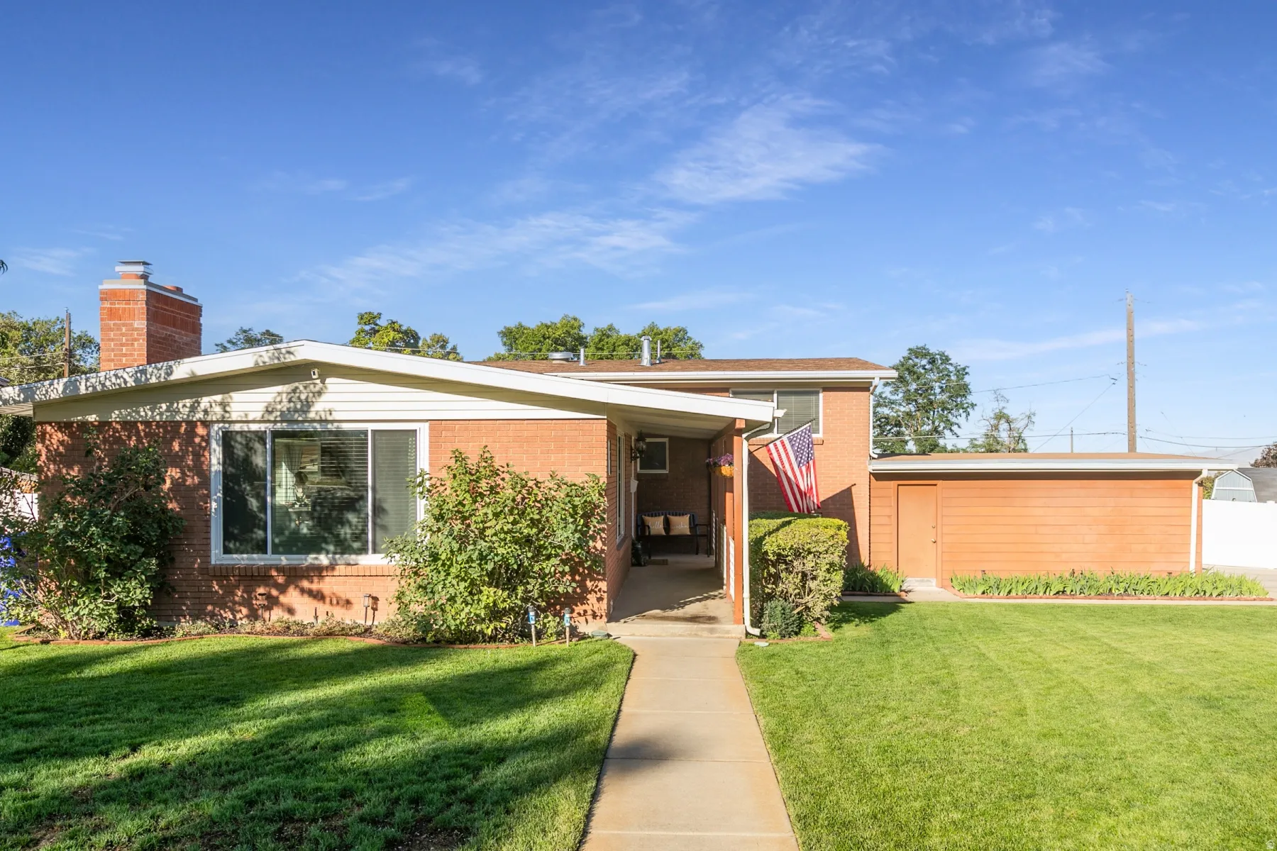 Side of the home with entrance. Brick exterior with white siding accents and a covered entryway