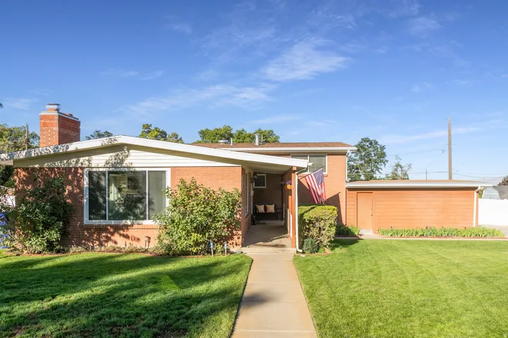 Side of the home with entrance. Brick exterior with white siding accents and a covered entryway