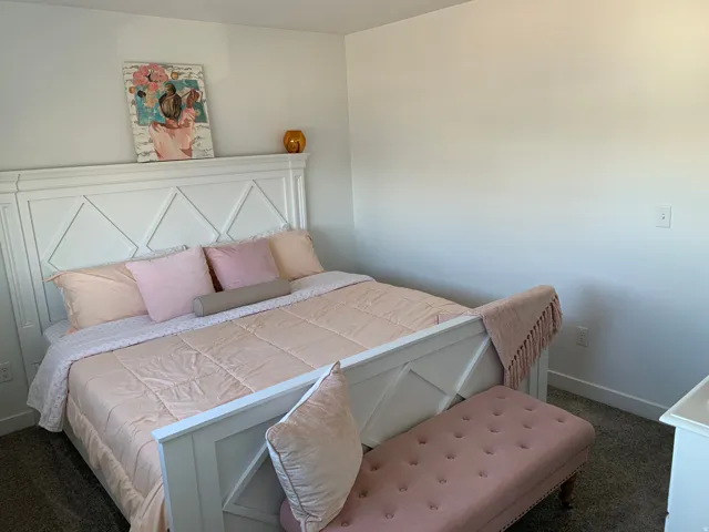 White painted bed frame with geometric headboard and footboard
