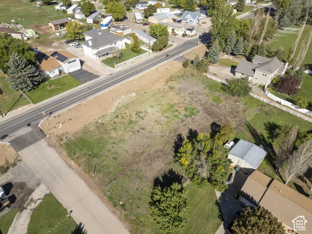 Expansive undeveloped parcel with established perimeter roads and surrounding residential properties