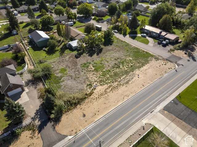 Expansive land parcel featuring direct road frontage and surrounding development