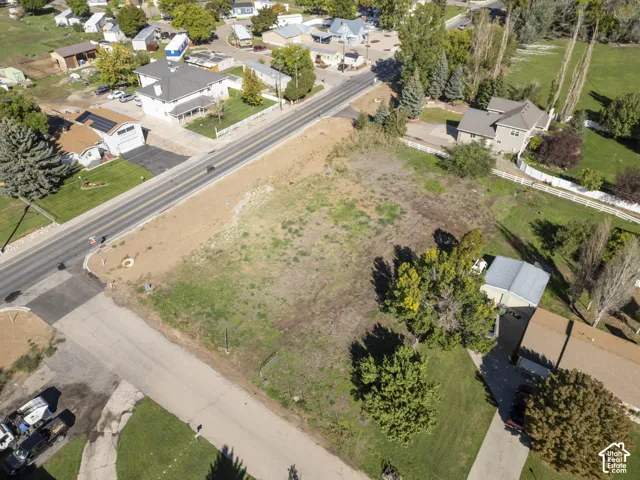 Expansive undeveloped land featuring mature trees and a residential street frontage
