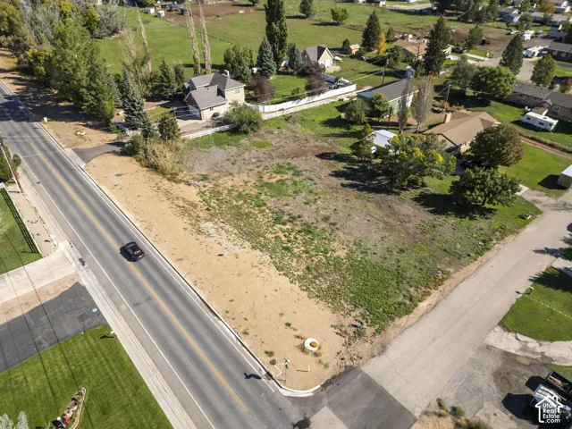 Expansive undeveloped lot featuring mixed terrain, roadside frontage, and street corner positioning