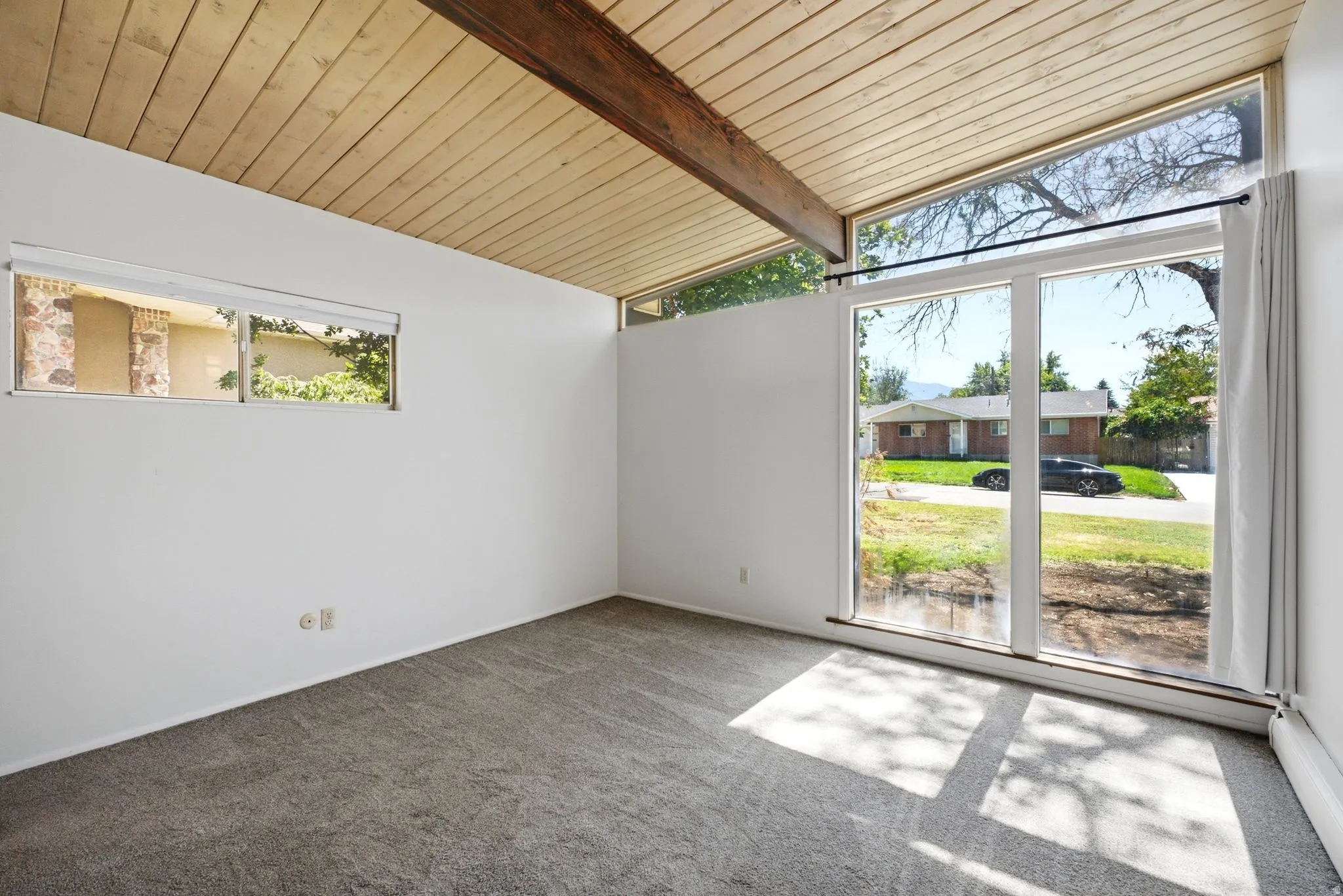 Vaulted wood-paneled ceiling with exposed wood beam