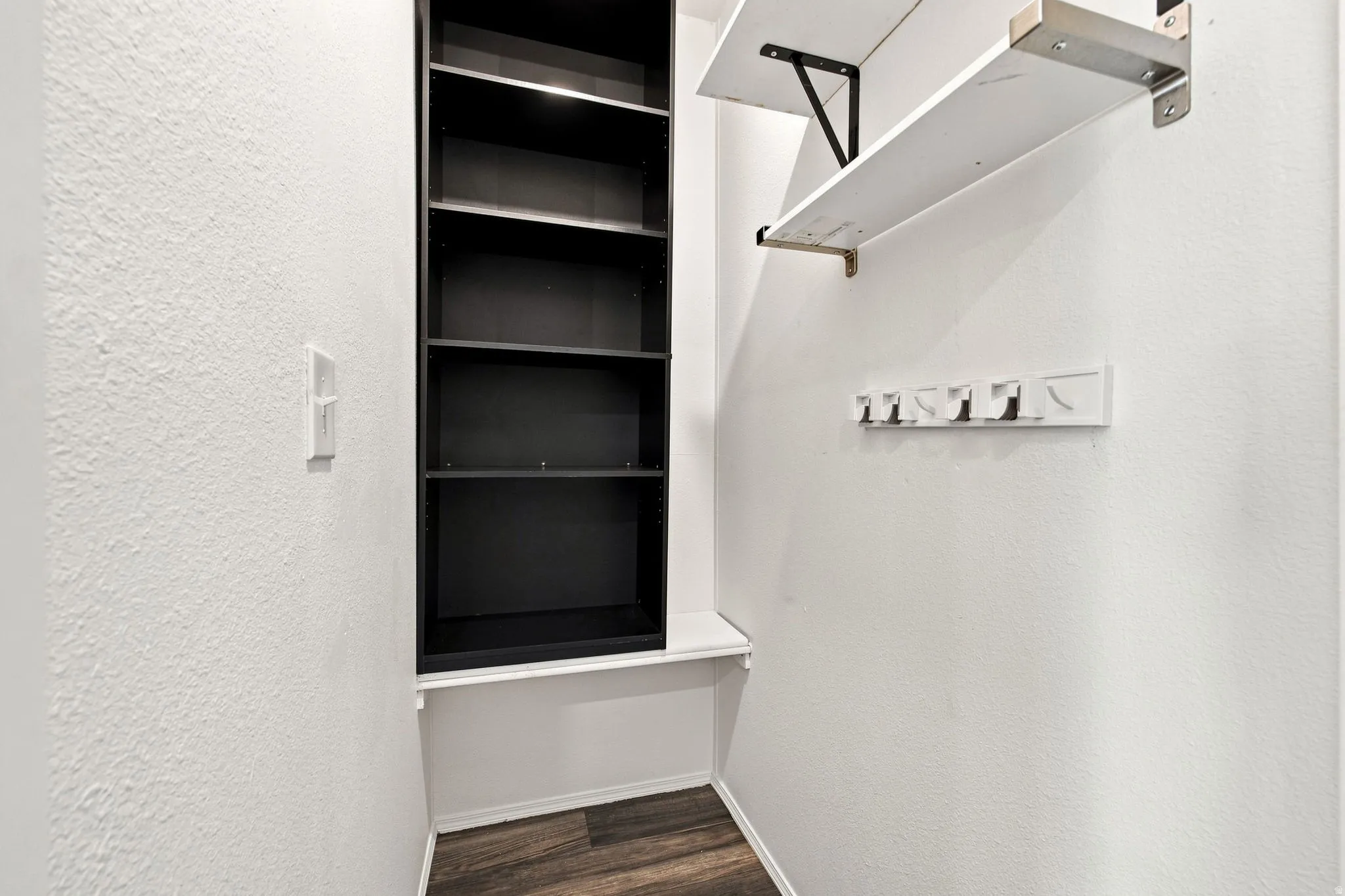 Built-in shelving, integrated coat hooks, and wood-finish flooring