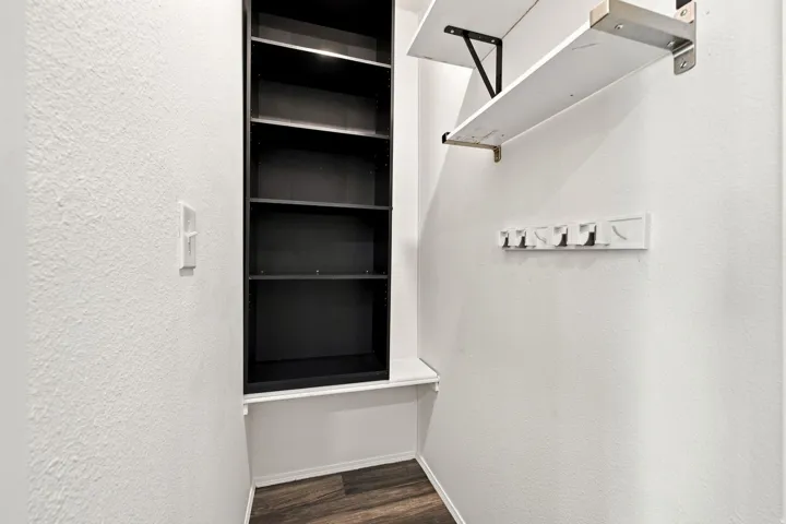 Built-in shelving, integrated coat hooks, and wood-finish flooring
