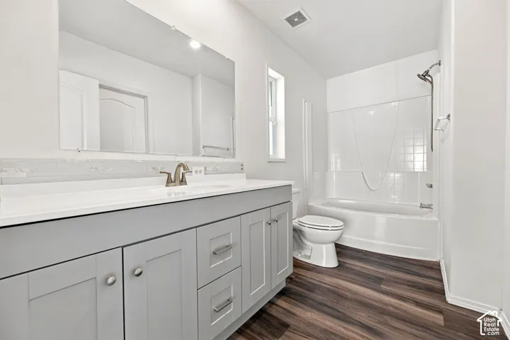 Dual-sink vanity with light gray cabinetry, white countertop, and brushed nickel fixtures