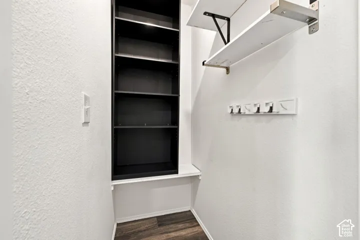 Built-in shelving, integrated coat hooks, and wood-finish flooring