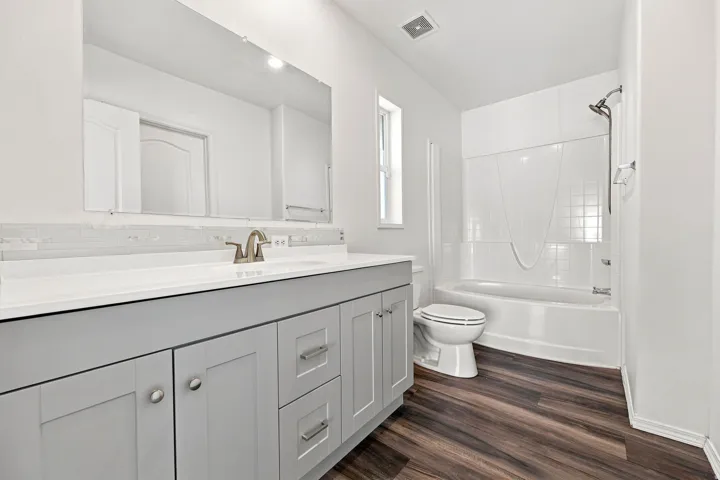 Dual-sink vanity with light gray cabinetry, white countertop, and brushed nickel fixtures