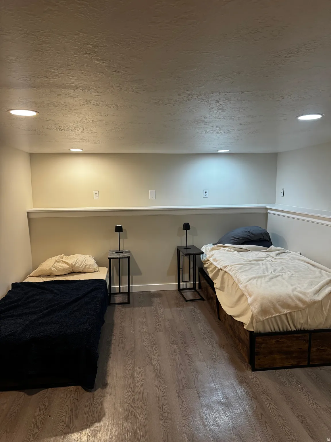 Recessed ceiling lighting, wood-finish flooring, two-tone wall paint, and white trim