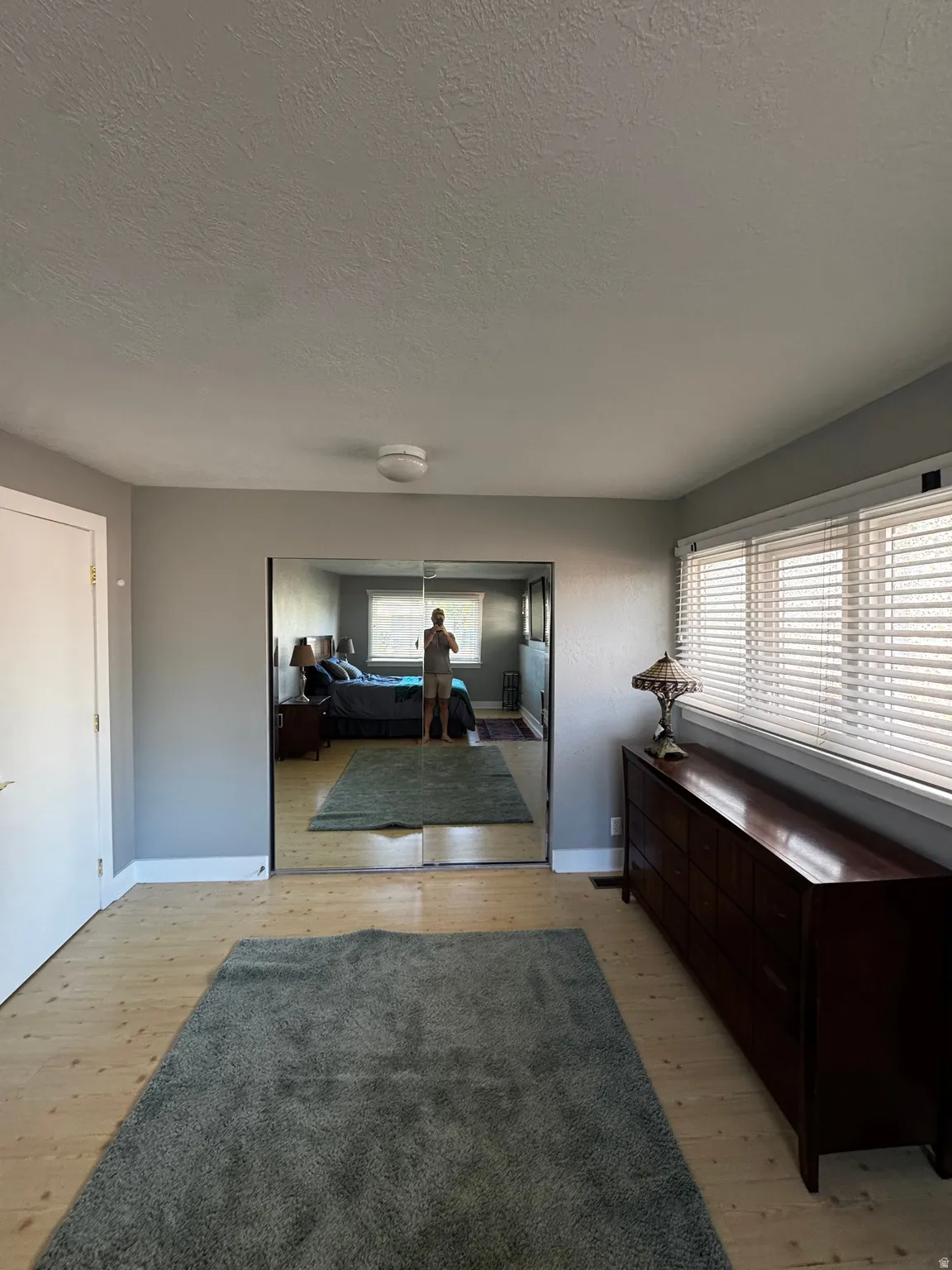 Light wood-finish flooring with a ceiling-mounted light fixture