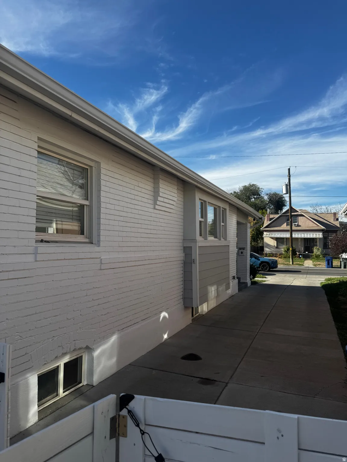 White brick exterior with grey siding accents