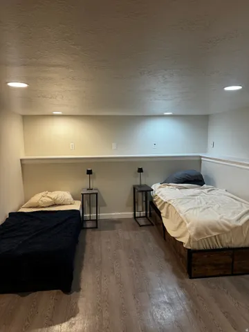 Recessed ceiling lighting, wood-finish flooring, two-tone wall paint, and white trim