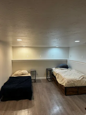 Recessed lighting, wood-finish flooring, and a chair rail molding