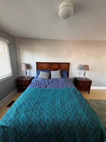Wood-finish flooring, recessed ceiling lighting, and window blinds
