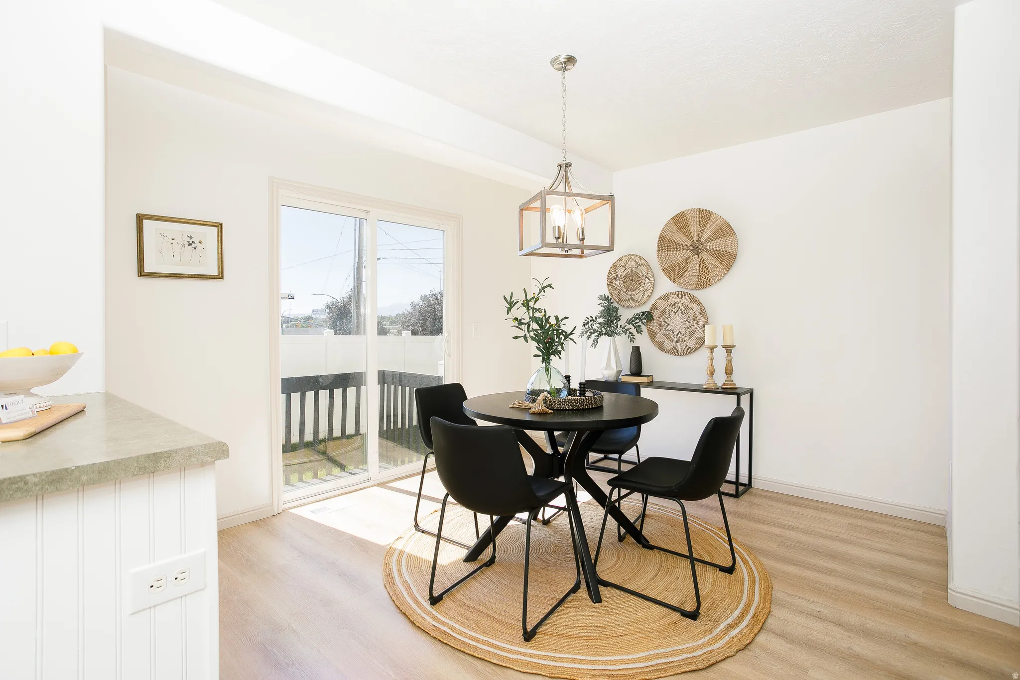 Slider door with exterior balcony, wood-finish flooring, recessed lighting, and a modern chandelier