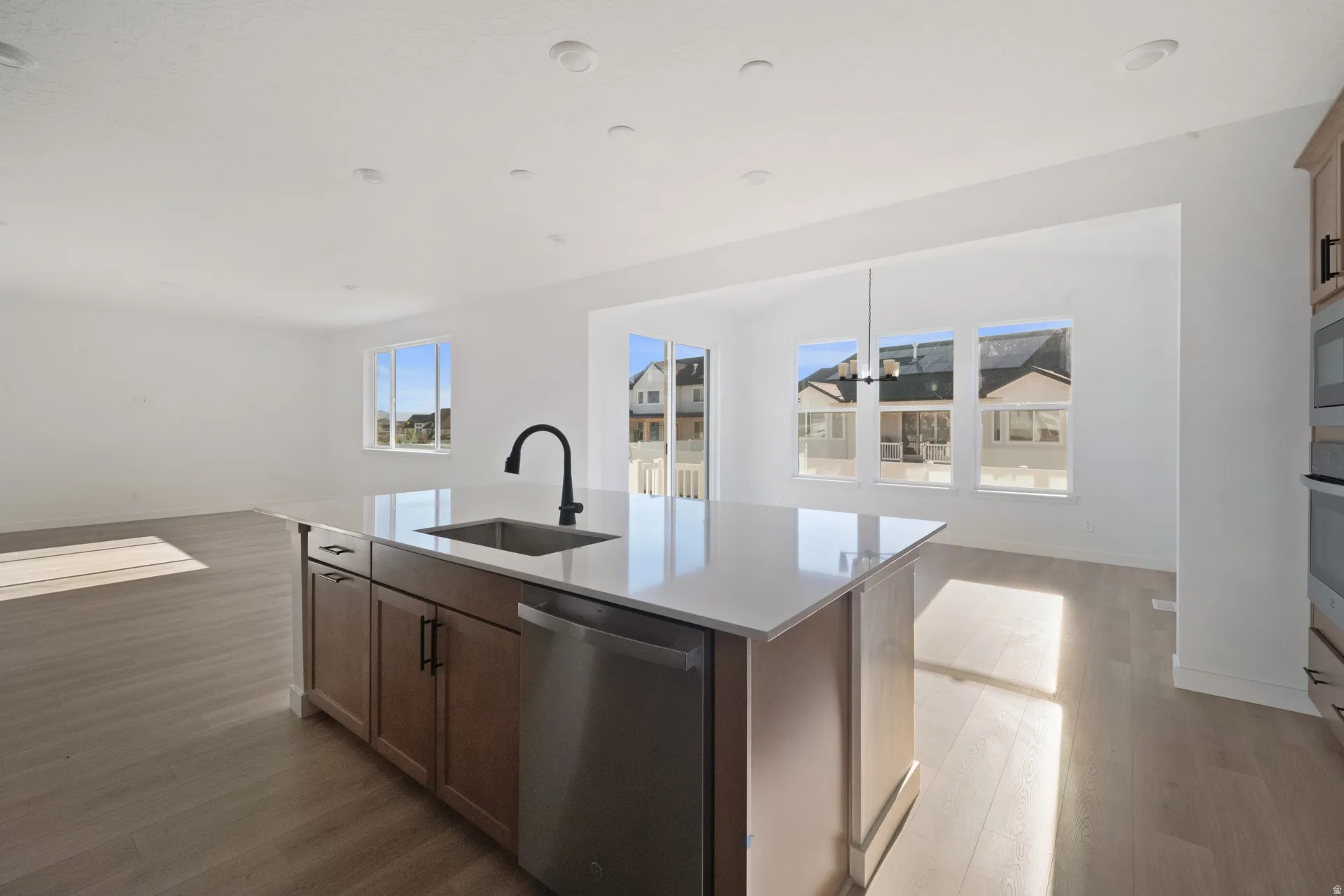 Kitchen island with an undermount sink, a matte black faucet, and a built-in dishwasher