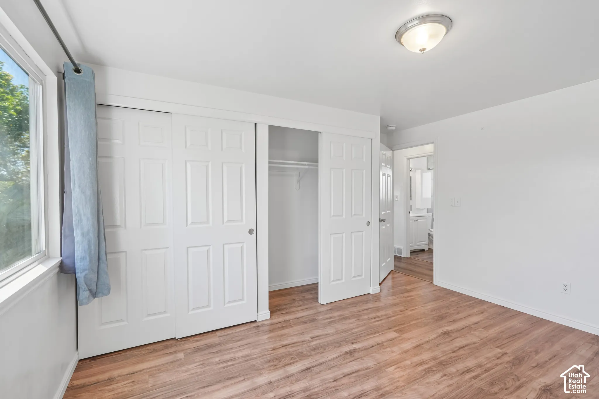 Wood-finish flooring with white walls and trim