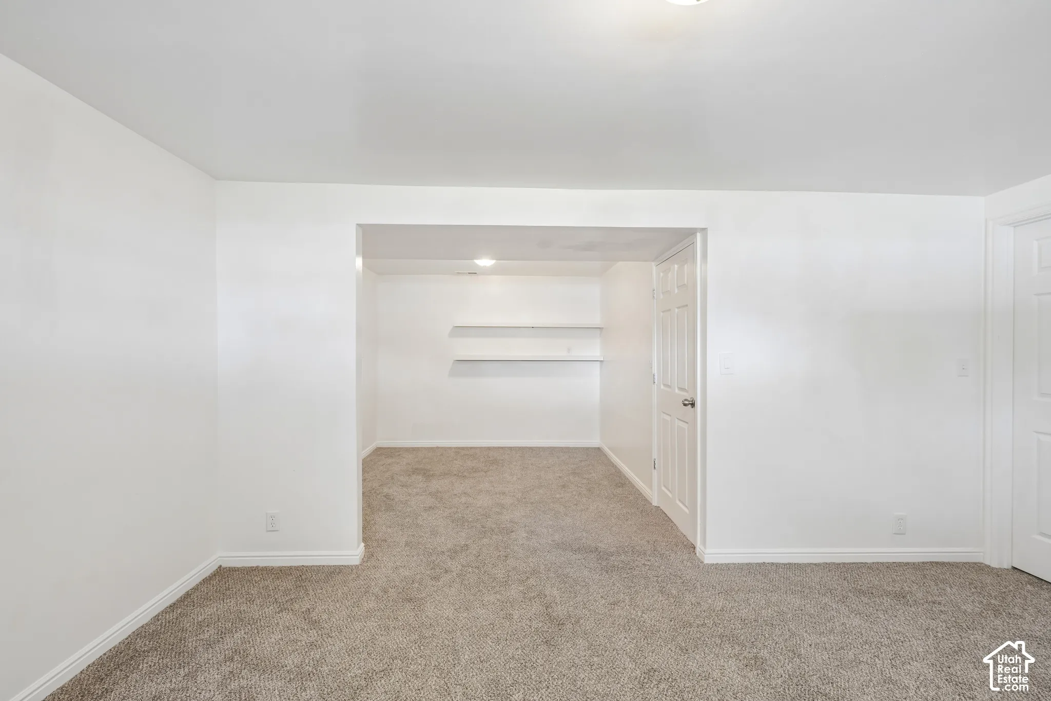 Plush gray carpeting throughout, featuring white walls and trim