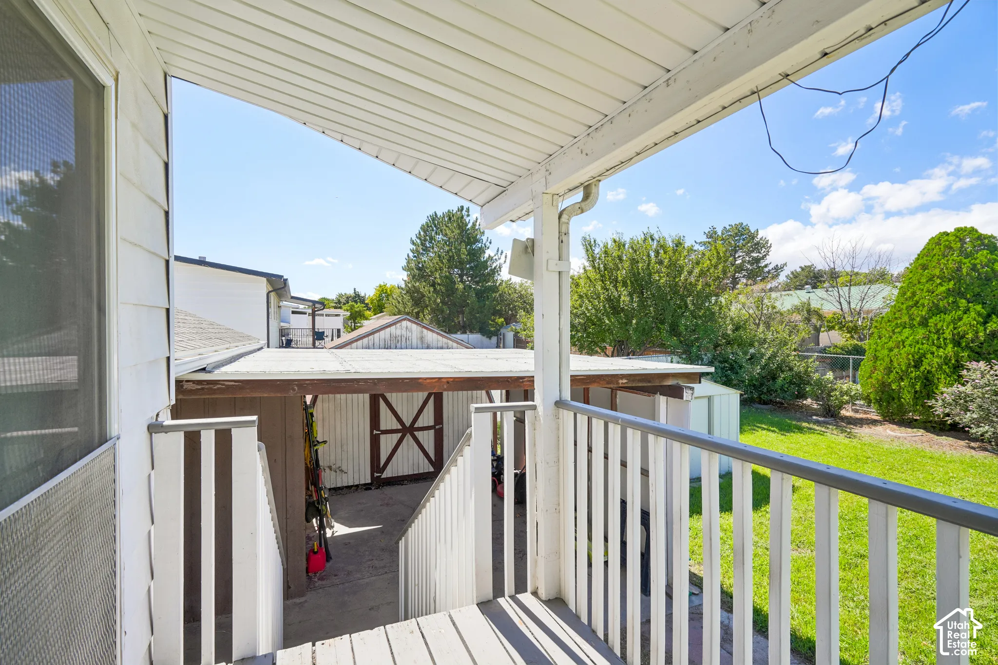 Covered exterior porch with wood decking