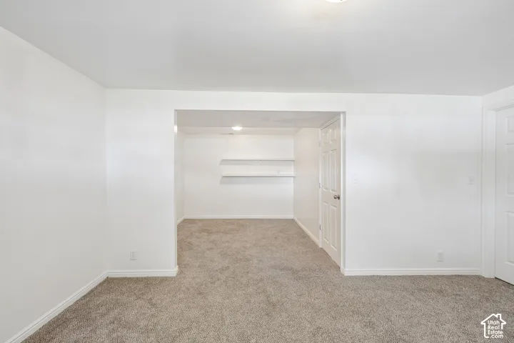 Plush gray carpeting throughout, featuring white walls and trim