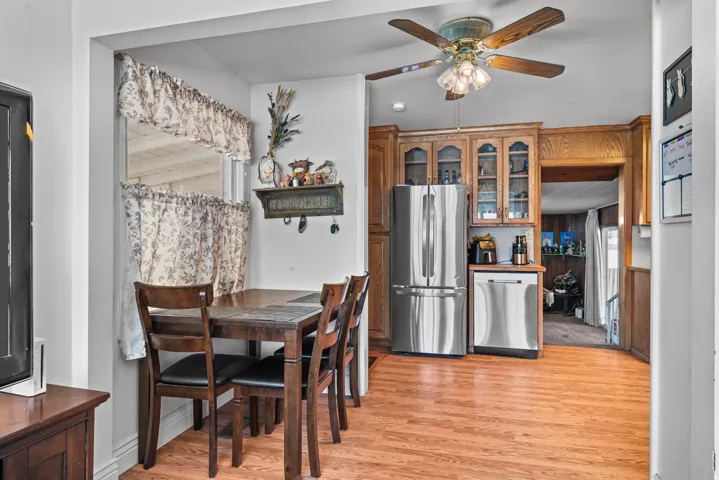 Wood-finish flooring throughout, complemented by a ceiling fan with integrated lighting