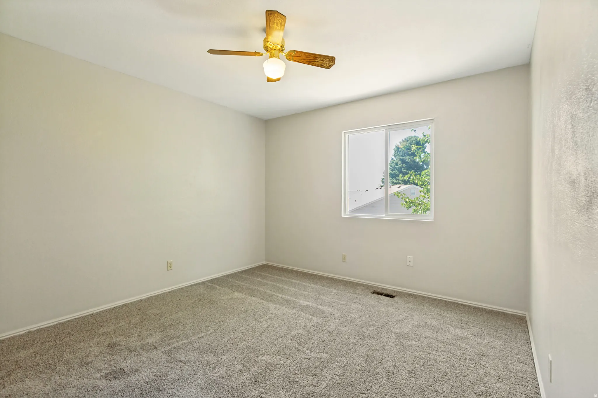 Secondary  Bedroom - Recessed window with exterior foliage, ceiling fan light fixture, and textured wall finish