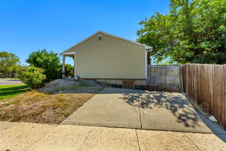 ADU Parking - Concrete driveway and walkway with a wood fence bordering the property