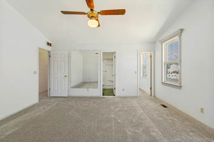 Primary Bedroom -  Room with carpeted flooring, a ceiling fan, and a trimmed window