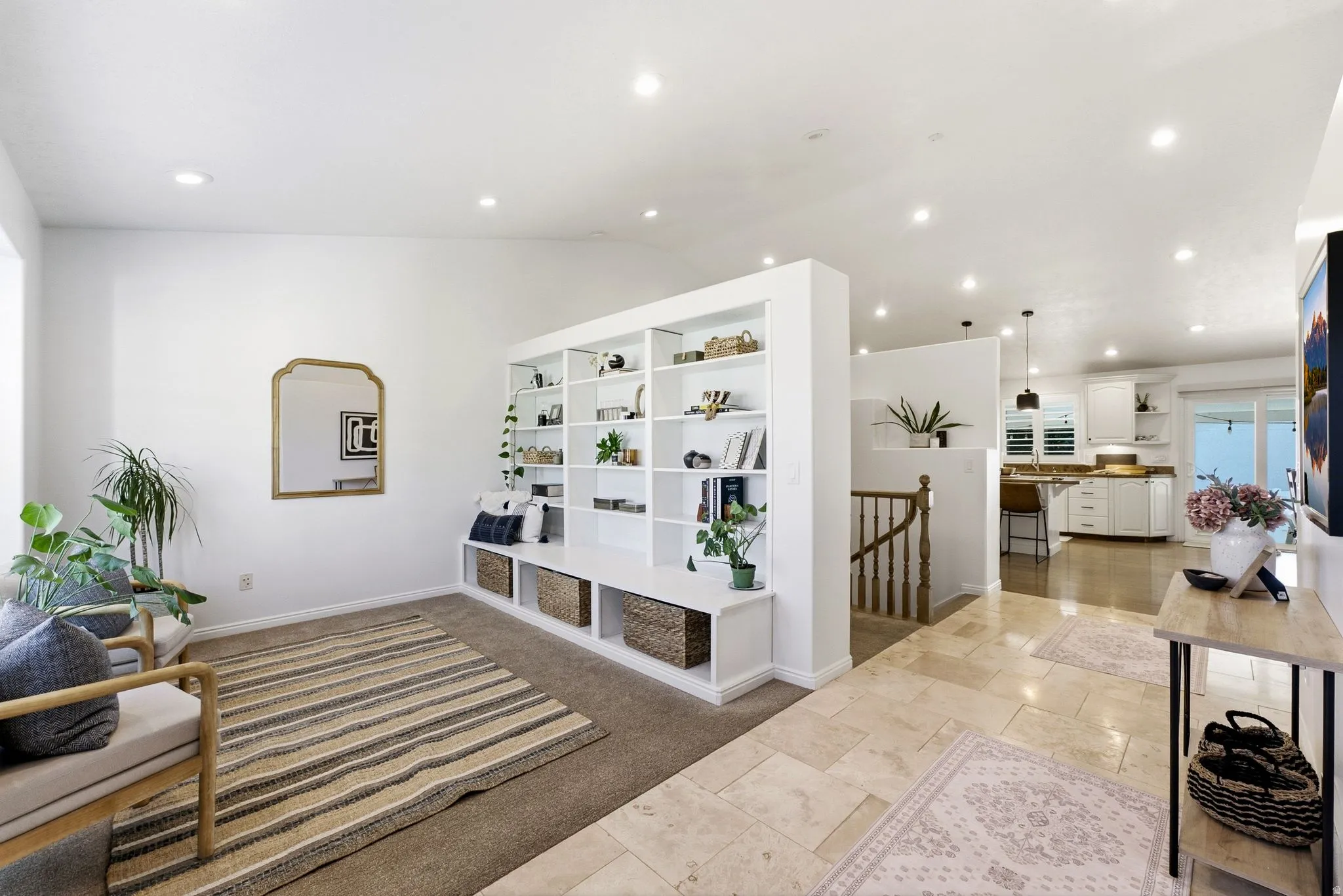 Built-in shelving unit with lower storage, recessed ceiling lighting, light-toned wall paint, and a tiled entryway