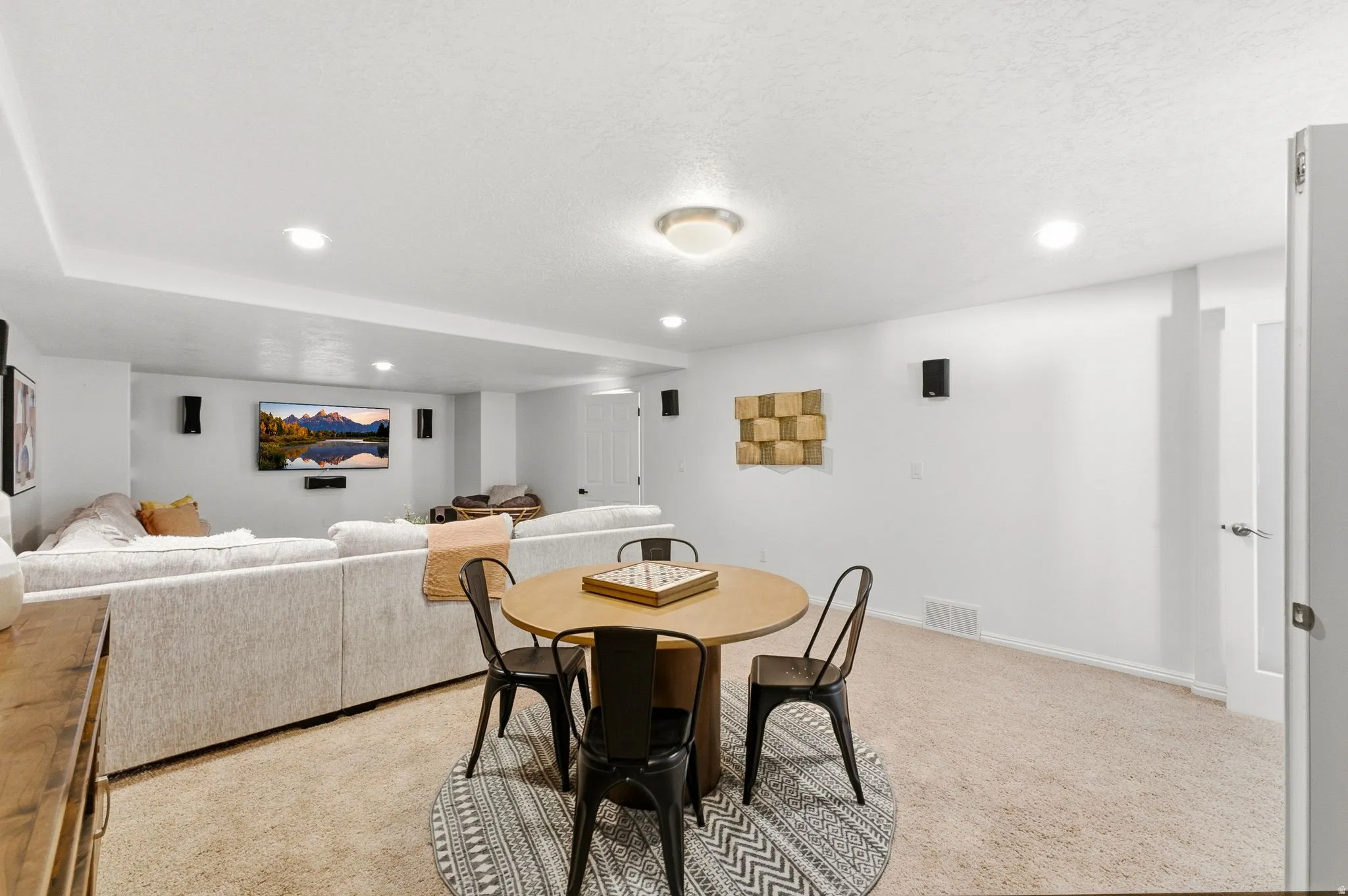 Recessed ceiling lighting with additional flush-mount fixture, carpeted flooring, and white painted walls