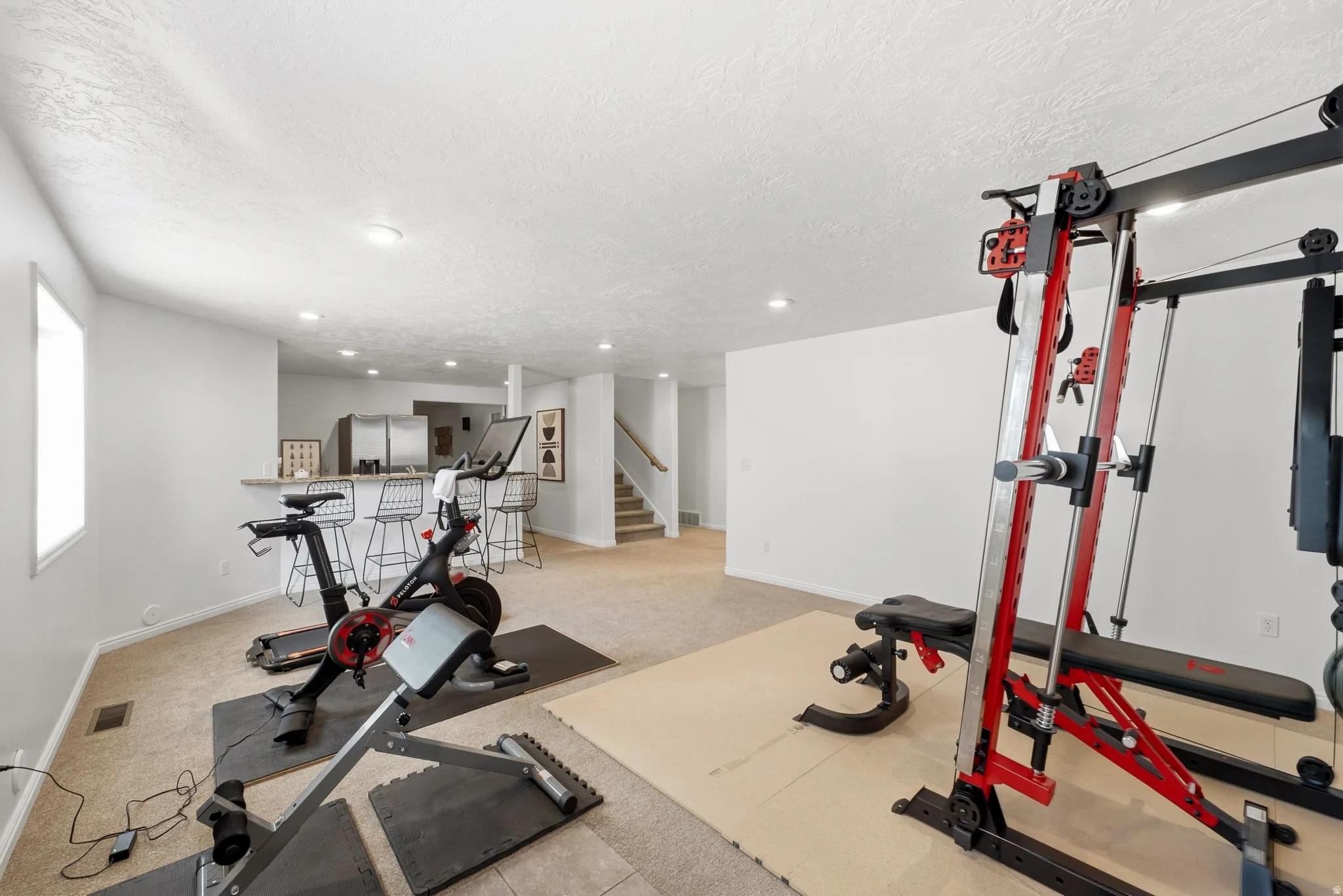 Recessed lighting illuminates the carpeted floor