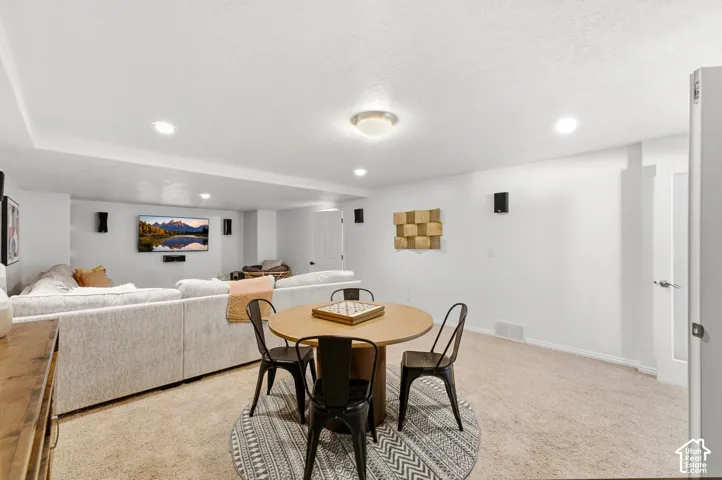Recessed ceiling lighting with additional flush-mount fixture, carpeted flooring, and white painted walls