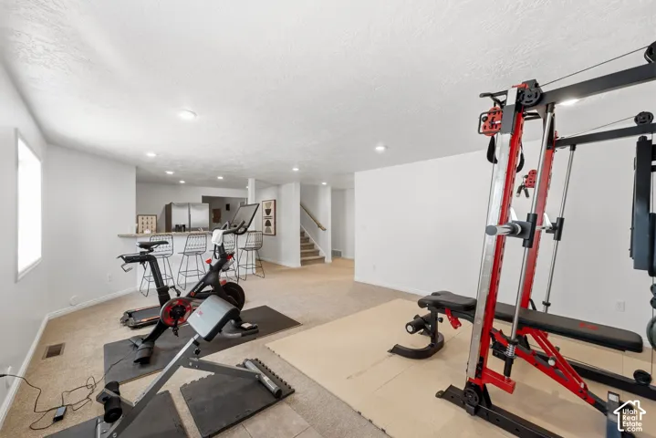 Recessed lighting illuminates the carpeted floor