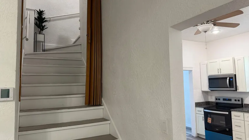 White painted staircase with wood trim