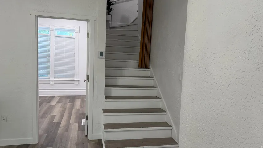 Staircase with carpeted treads and white risers